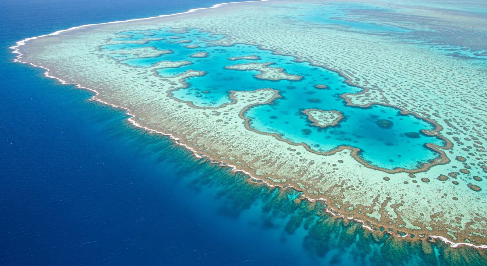 Aerial view of the Great Barrier Reef with turquoise waters and coral formations