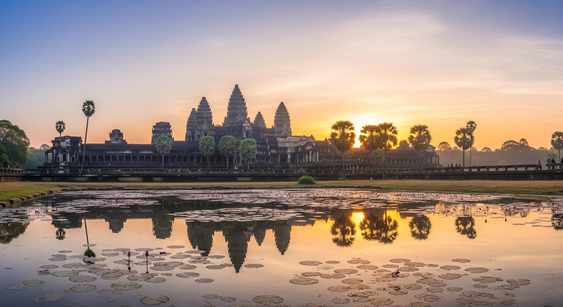 Angkor Wat temple at sunrise with reflecting pool