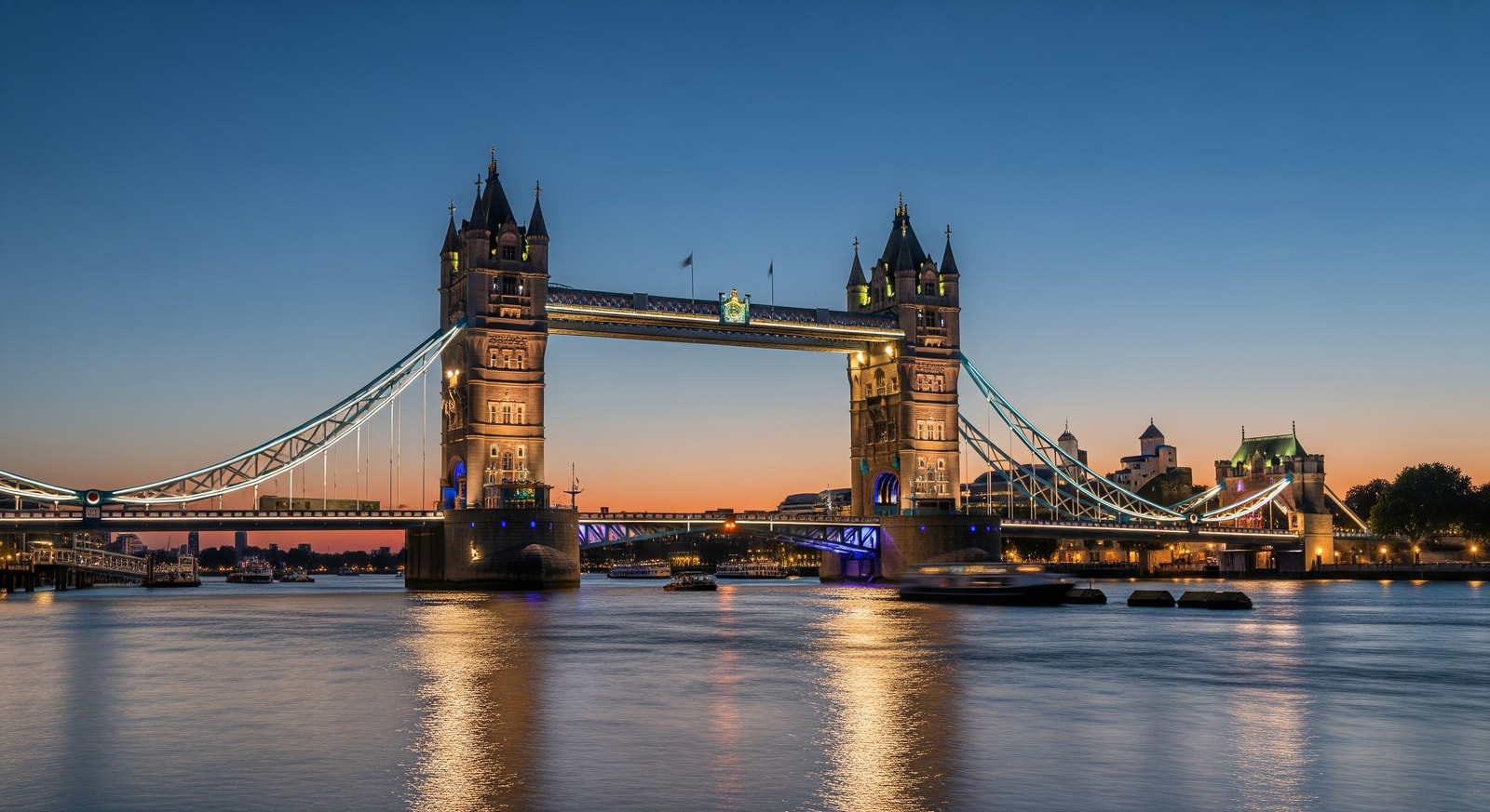 Tower Bridge in London at dusk with lights reflecting on the River Thames
