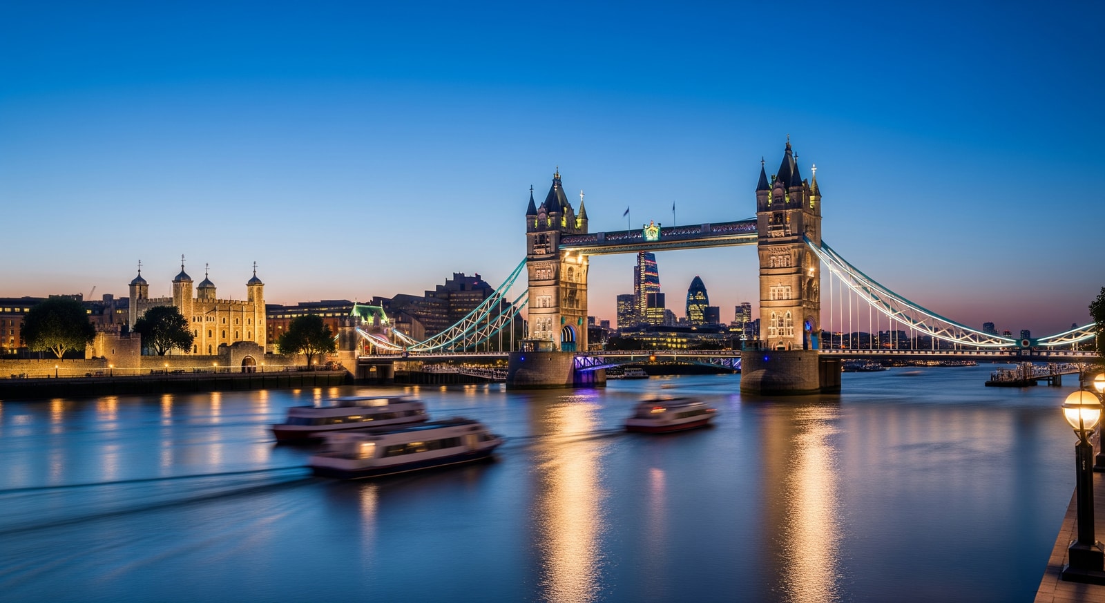 Tower Bridge in London at twilight with city lights reflecting on the Thames