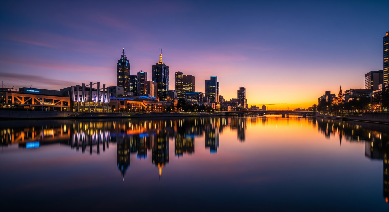 Melbourne city skyline reflected in Yarra River at twilight with Federation Square visible