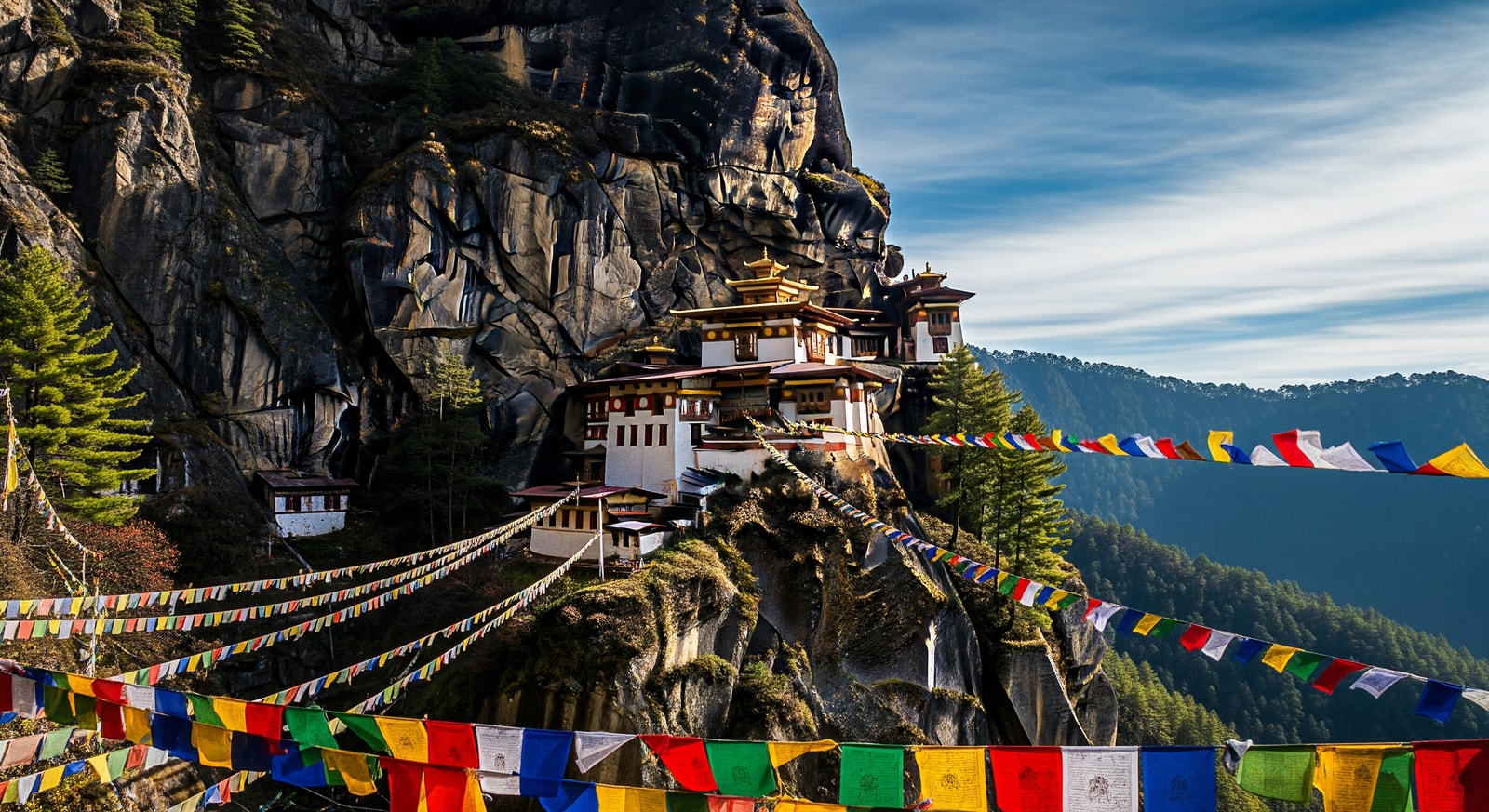 Iconic Tiger's Nest Monastery clinging to sheer cliff face with prayer flags fluttering in the wind