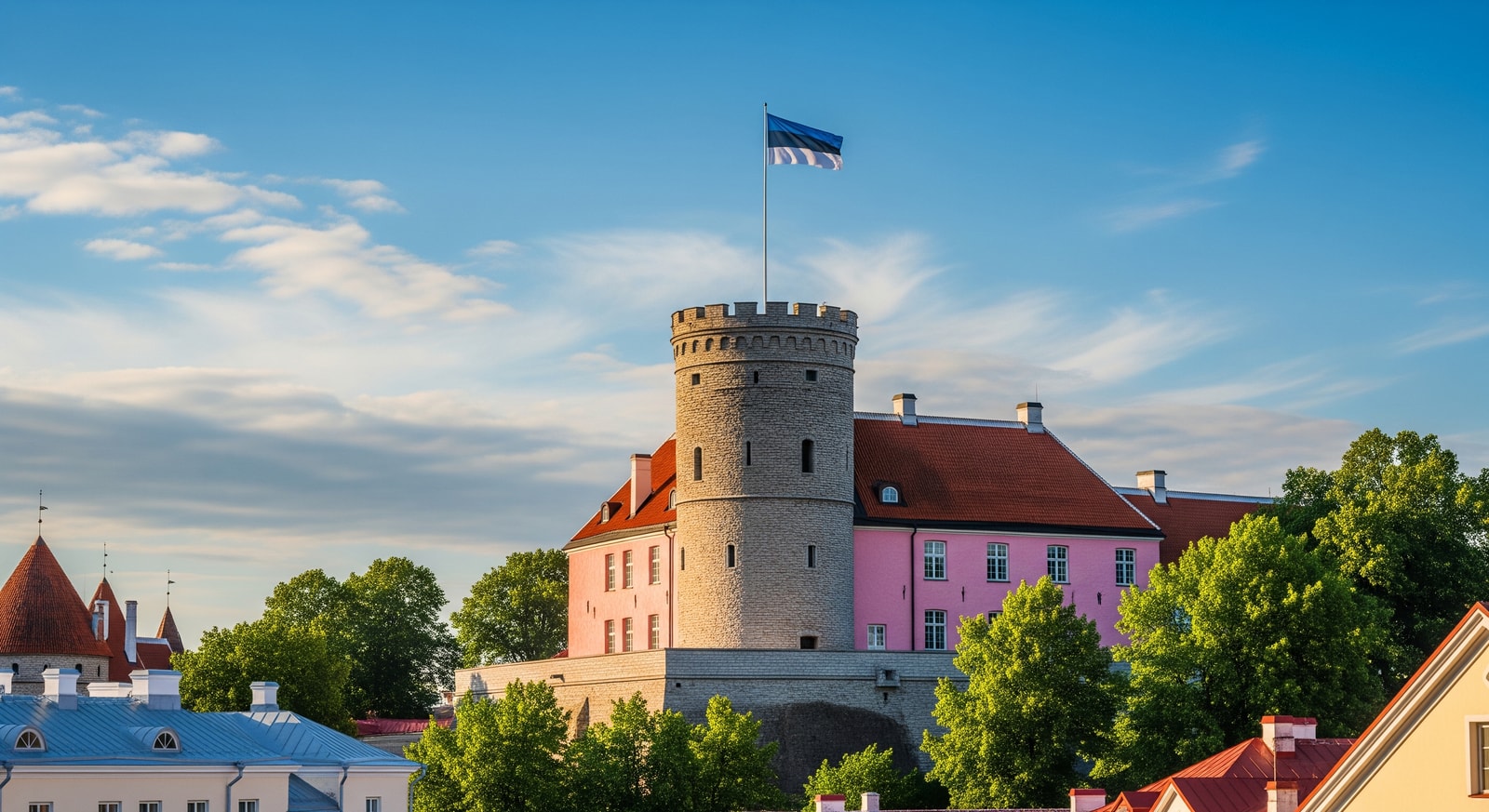 Estonian Parliament building Toompea Castle with pink facade and flag flying against blue sky