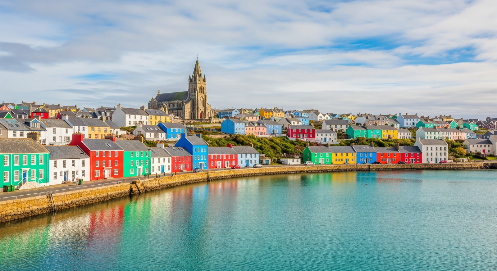 Colorful houses along the waterfront of Stanley harbor with the Christ Church Cathedral visible