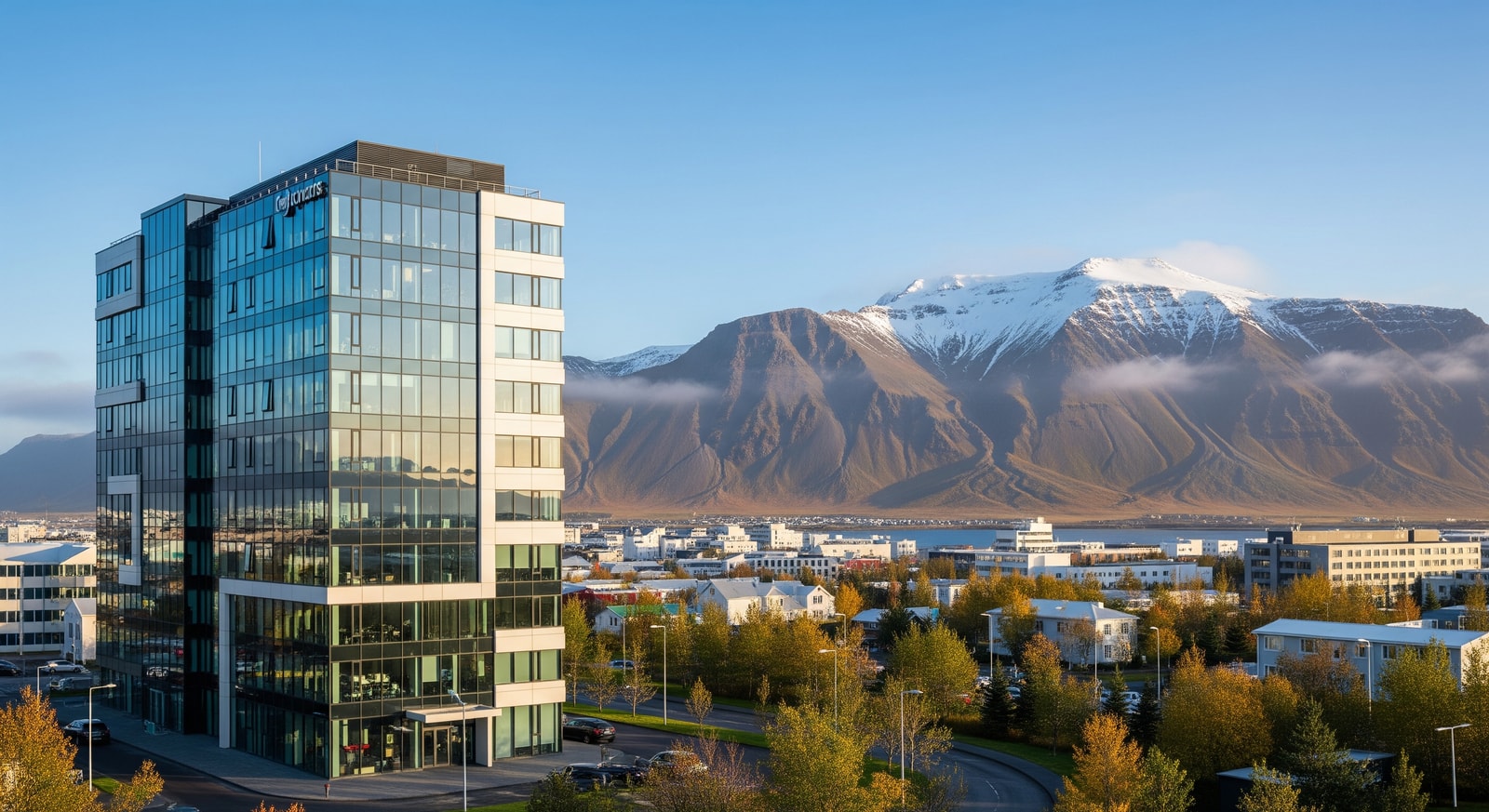 Modern office building in Reykjavik's business district with mountains visible in the background