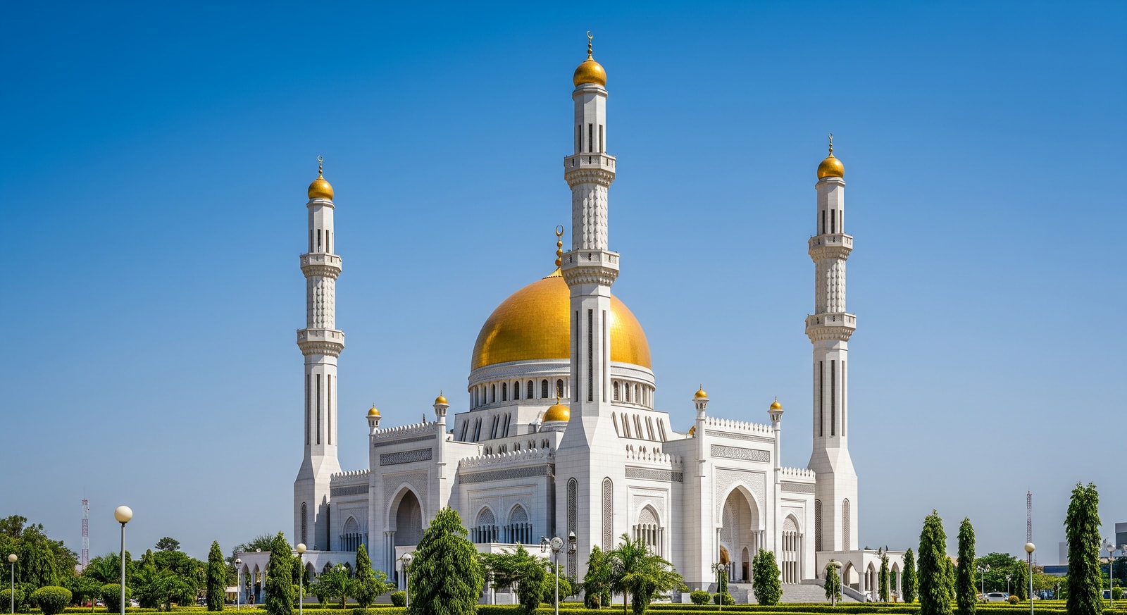 The Nigerian National Mosque in Abuja with its golden dome and minarets against a clear blue sky