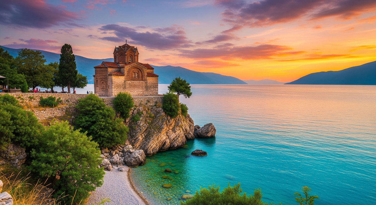 Historic Church of Saint John at Kaneo on the cliffs of Lake Ohrid with turquoise waters below at sunset