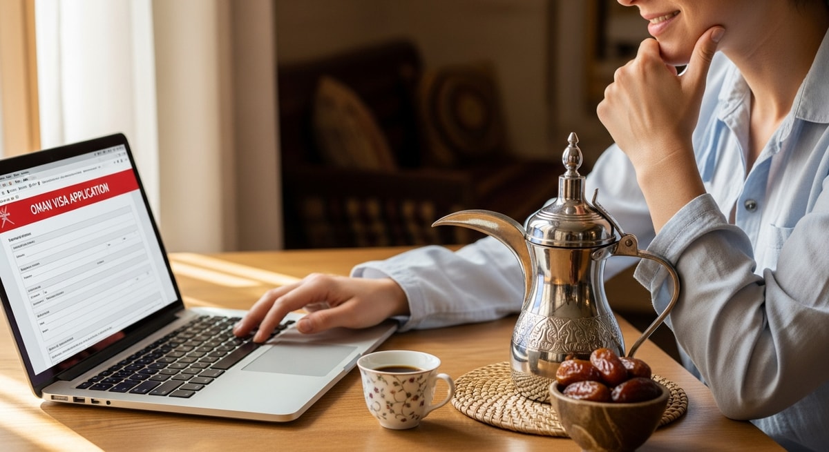 Traveler reviewing Oman visa application on laptop with traditional Omani coffee and dates nearby